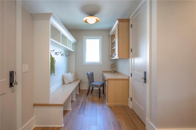 7736 N Donnelly Ave, Kansas City, MO 64158 - mudroom with light wood finished floors and a textured ceiling