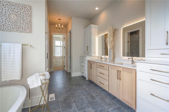 7736 N Donnelly Ave, Kansas City, MO 64158 - full bathroom featuring double vanity, a soaking tub, a chandelier, and recessed lighting