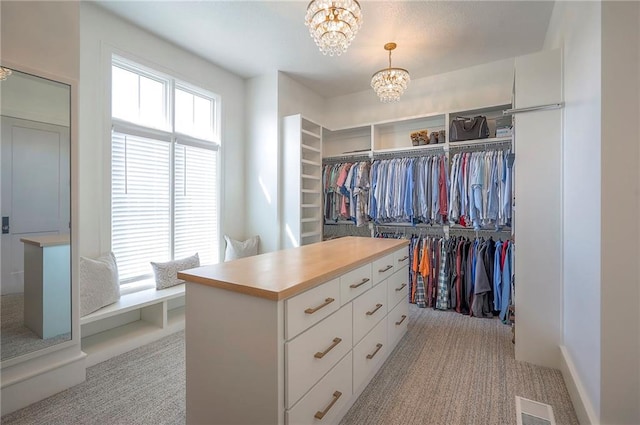 7736 N Donnelly Ave, Kansas City, MO 64158 - spacious closet featuring light carpet and a chandelier