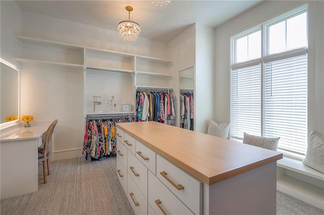 7736 N Donnelly Ave, Kansas City, MO 64158 - walk in closet with a chandelier and light colored carpet
