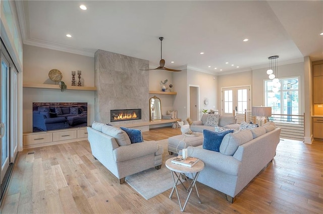 7736 N Donnelly Ave, Kansas City, MO 64158 - living room featuring light wood-style flooring, crown molding, recessed lighting, a fireplace, and ceiling fan
