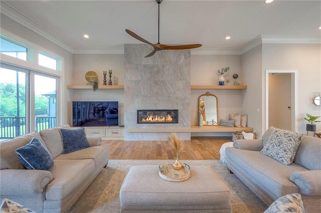 7736 N Donnelly Ave, Kansas City, MO 64158 - living area featuring ceiling fan, recessed lighting, wood finished floors, a fireplace, and crown molding