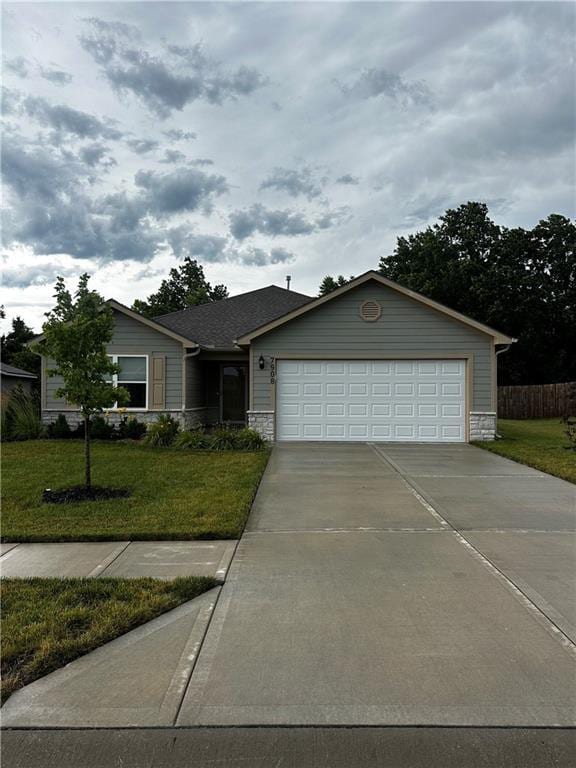 7908 SE 6th Ter, Blue Springs, MO 64014 - ranch-style home featuring a front yard, an attached garage, stone siding, and concrete driveway