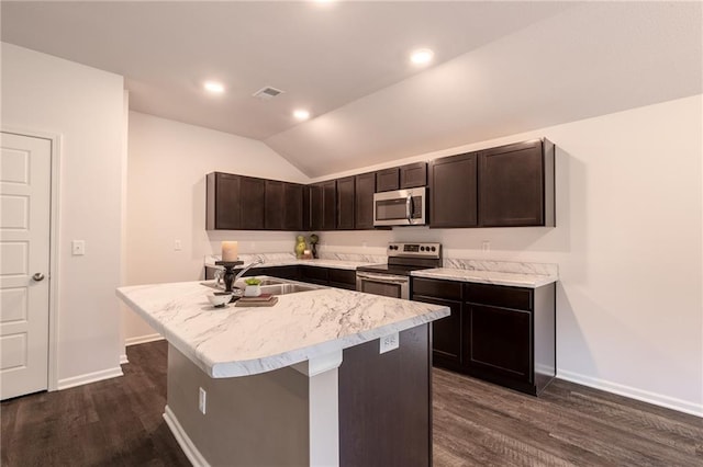 7908 SE 6th Ter, Blue Springs, MO 64014 - kitchen featuring appliances with stainless steel finishes, dark wood-type flooring, dark brown cabinetry, an island with sink, and vaulted ceiling