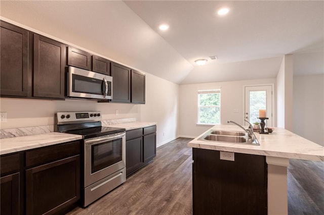 7908 SE 6th Ter, Blue Springs, MO 64014 - kitchen with appliances with stainless steel finishes, vaulted ceiling, dark wood-style floors, dark brown cabinets, and a center island with sink