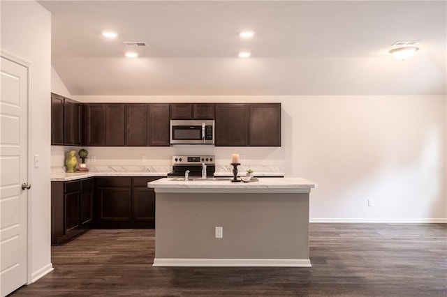 7908 SE 6th Ter, Blue Springs, MO 64014 - kitchen with stainless steel appliances, dark brown cabinetry, lofted ceiling, dark wood-style floors, and a kitchen island with sink