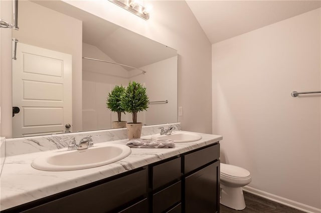 7908 SE 6th Ter, Blue Springs, MO 64014 - bathroom featuring vaulted ceiling, double vanity, and wood finished floors