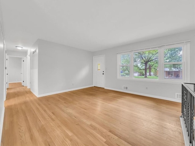 3717 S Hocker St, Independence, MO 64055 - unfurnished living room featuring light wood-style floors and baseboards