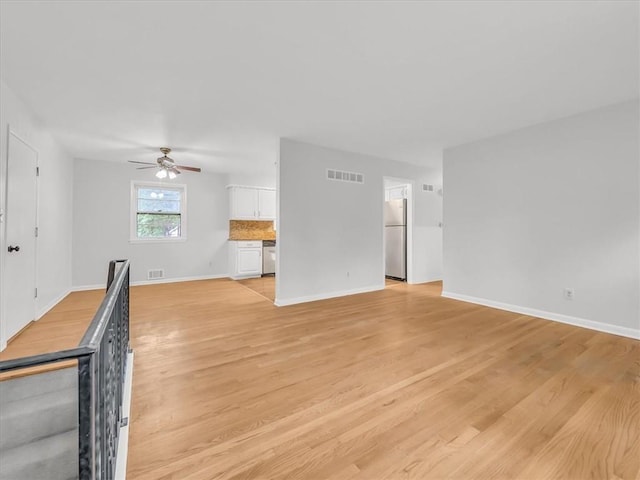 3717 S Hocker St, Independence, MO 64055 - unfurnished living room with a ceiling fan and light wood finished floors