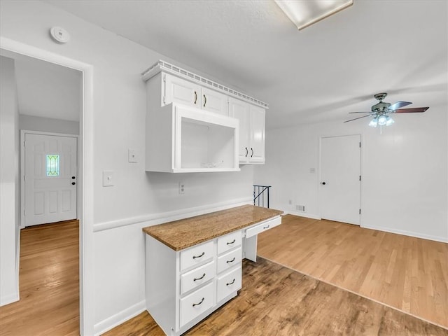 3717 S Hocker St, Independence, MO 64055 - kitchen featuring light wood-style flooring, white cabinets, and a ceiling fan