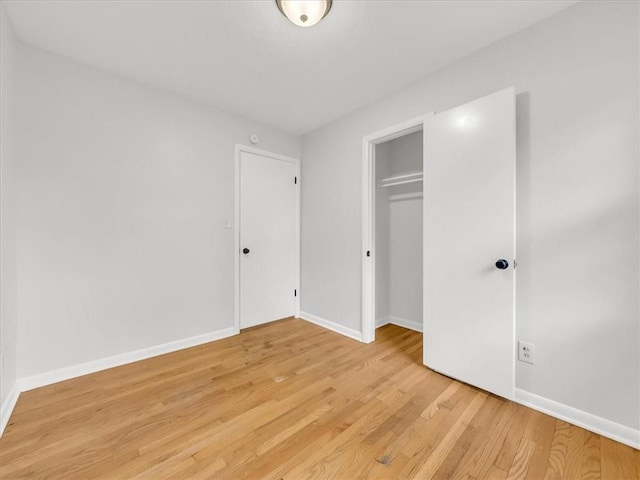 3717 S Hocker St, Independence, MO 64055 - unfurnished bedroom with light wood finished floors and a closet