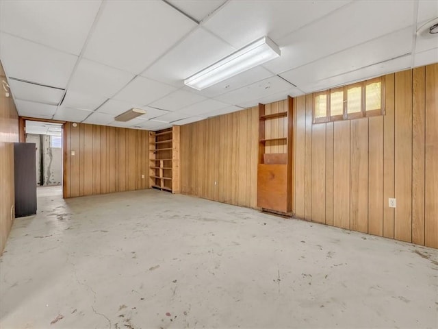3717 S Hocker St, Independence, MO 64055 - below grade area with wooden walls, plenty of natural light, and a drop ceiling