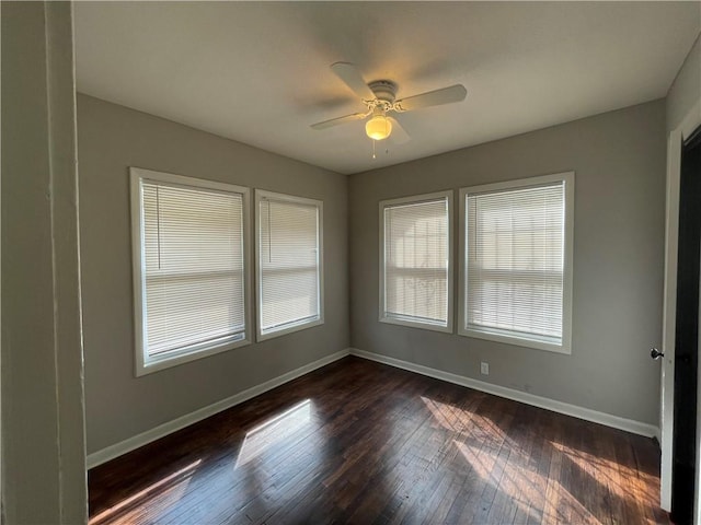 4916 Wabash Ave, Kansas City, MO 64130 - empty room with dark wood finished floors and ceiling fan