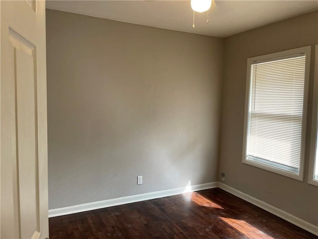 4916 Wabash Ave, Kansas City, MO 64130 - empty room with dark wood-style floors and a ceiling fan