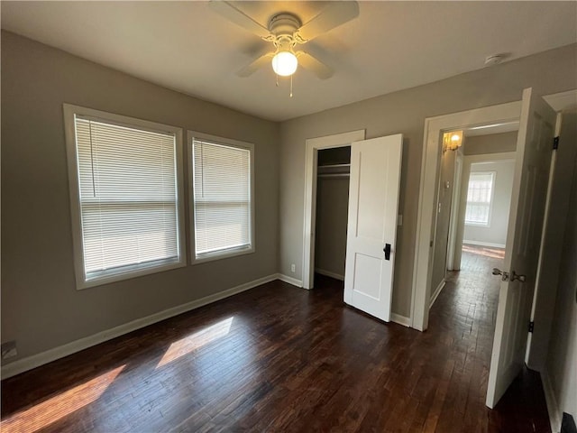 4916 Wabash Ave, Kansas City, MO 64130 - unfurnished bedroom with dark wood-style floors, a closet, and a ceiling fan