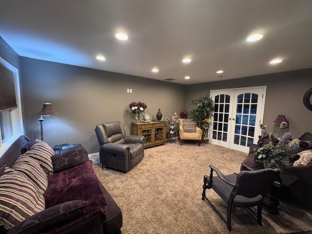 1878 US Highway 54, Iola, KS 66749 - living area featuring french doors, carpet floors, and recessed lighting