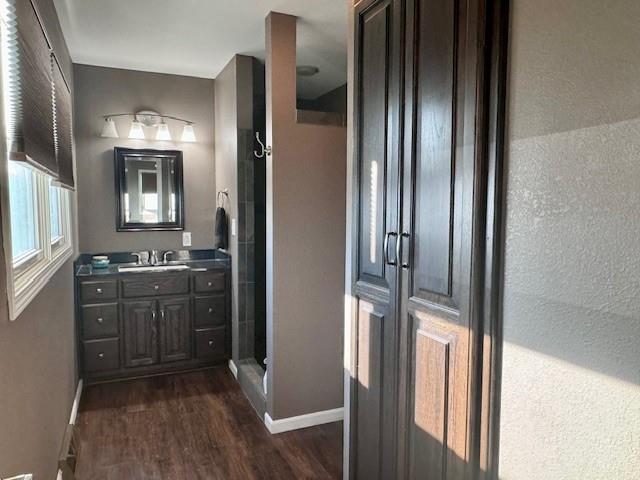 1878 US Highway 54, Iola, KS 66749 - full bathroom with wood finished floors, vanity, and a stall shower