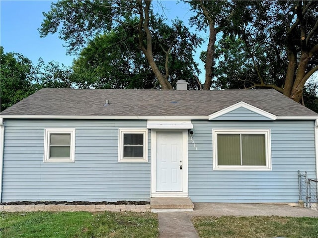 2321 Englewood Ct, Independence, MO 64052 - view of front of property featuring a shingled roof and a chimney