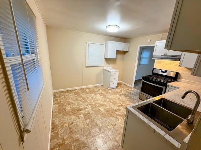 2321 Englewood Ct, Independence, MO 64052 - kitchen featuring stainless steel gas range oven, ventilation hood, white cabinetry, decorative backsplash, and crown molding