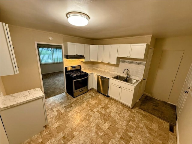 2321 Englewood Ct, Independence, MO 64052 - kitchen featuring stainless steel appliances, white cabinets, decorative backsplash, stone finish flooring, and under cabinet range hood