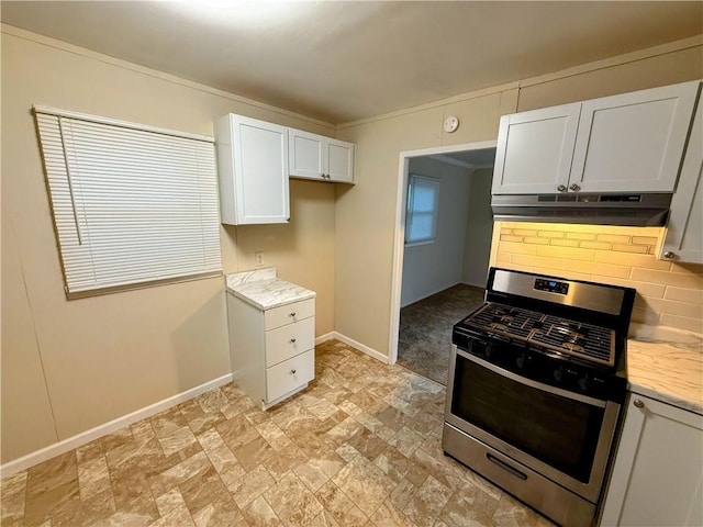 2321 Englewood Ct, Independence, MO 64052 - kitchen with stainless steel range with gas stovetop, under cabinet range hood, white cabinetry, light stone finish floors, and light stone countertops