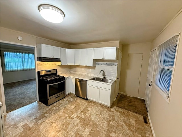 2321 Englewood Ct, Independence, MO 64052 - kitchen with stainless steel appliances, under cabinet range hood, stone finish floors, light countertops, and white cabinetry