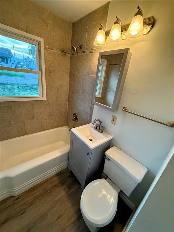 2321 Englewood Ct, Independence, MO 64052 - full bath with vanity, wood finished floors, and shower / bath combination