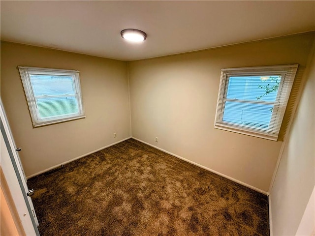 2321 Englewood Ct, Independence, MO 64052 - spare room with plenty of natural light and dark colored carpet