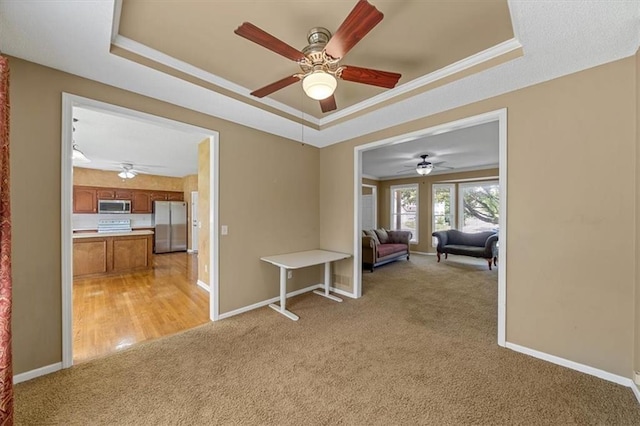 6715 W 148th Ter, Overland Park, KS 66223 - unfurnished room with a raised ceiling, light carpet, a ceiling fan, and ornamental molding