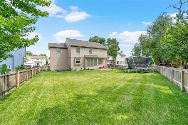 6715 W 148th Ter, Overland Park, KS 66223 - back of house featuring a trampoline and a fenced backyard