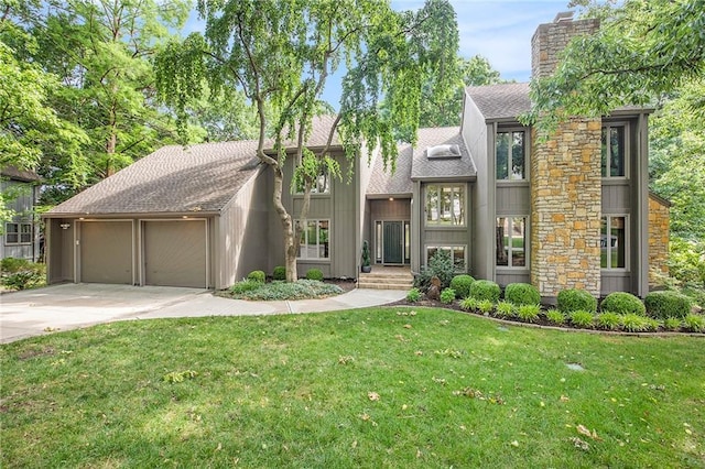 11909 Goddard St, Overland Park, KS 66213 - view of front of home with a chimney, an attached garage, roof with shingles, and a front lawn