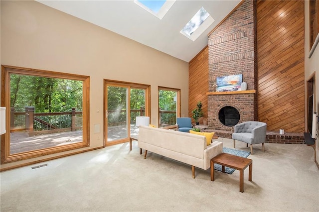 11909 Goddard St, Overland Park, KS 66213 - living area with high vaulted ceiling, carpet, a skylight, wood walls, and a fireplace