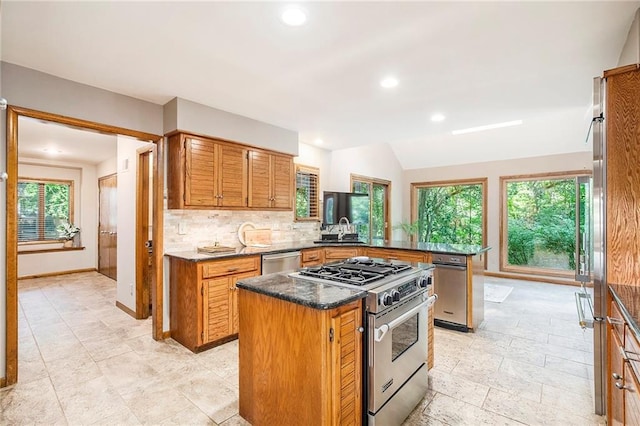 11909 Goddard St, Overland Park, KS 66213 - kitchen featuring appliances with stainless steel finishes, tasteful backsplash, a kitchen island, a peninsula, and recessed lighting