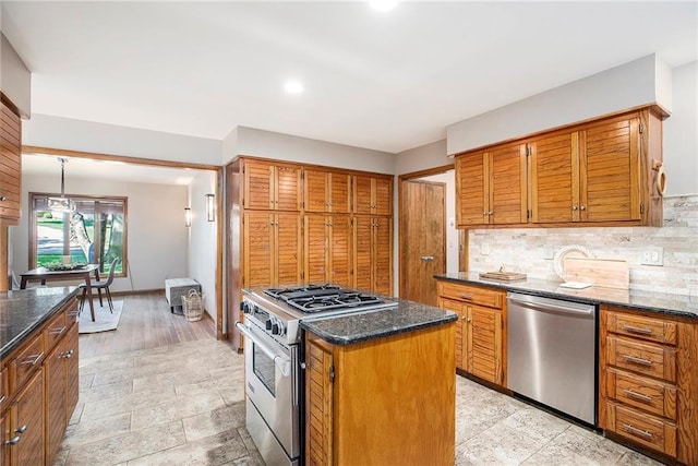 11909 Goddard St, Overland Park, KS 66213 - kitchen featuring stainless steel appliances, tasteful backsplash, a center island, brown cabinetry, and recessed lighting