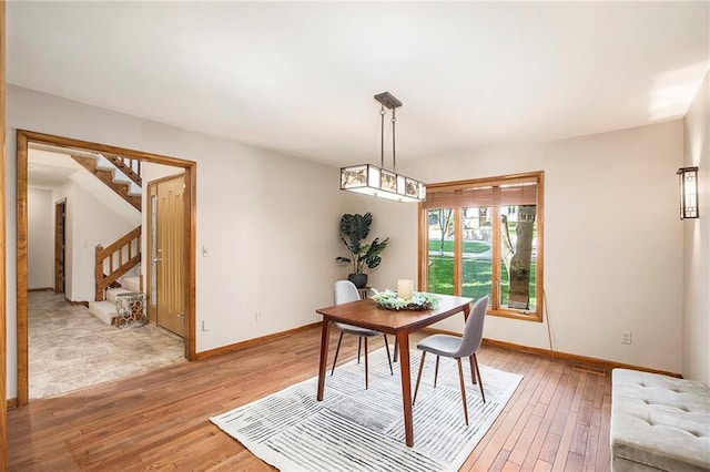 11909 Goddard St, Overland Park, KS 66213 - dining room with stairway and light wood-style flooring