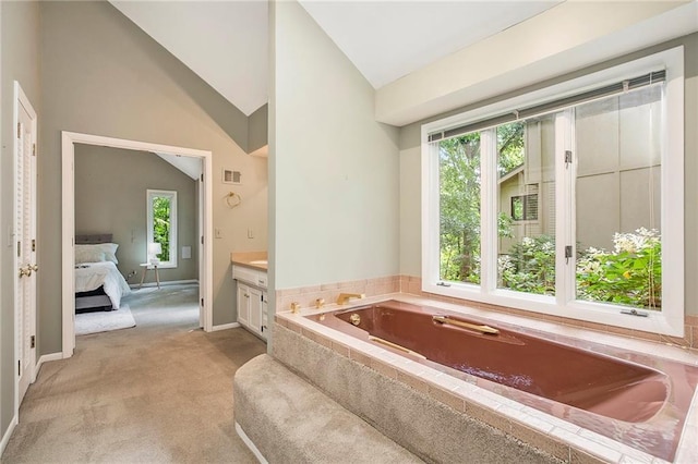 11909 Goddard St, Overland Park, KS 66213 - bathroom featuring vaulted ceiling, healthy amount of natural light, a bath, vanity, and ensuite bath