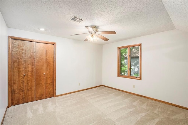 11909 Goddard St, Overland Park, KS 66213 - unfurnished bedroom featuring light carpet, a closet, a ceiling fan, and a textured ceiling