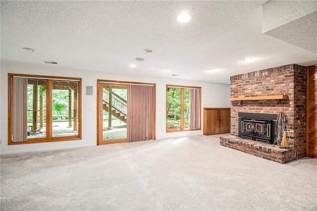 11909 Goddard St, Overland Park, KS 66213 - unfurnished living room with a textured ceiling, recessed lighting, and carpet