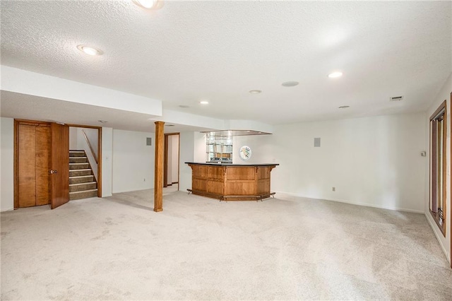 11909 Goddard St, Overland Park, KS 66213 - finished below grade area with a dry bar, stairs, light colored carpet, recessed lighting, and a textured ceiling