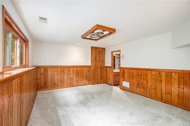 11909 Goddard St, Overland Park, KS 66213 - carpeted spare room with a wainscoted wall and wooden walls