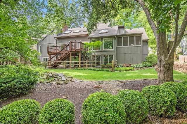 11909 Goddard St, Overland Park, KS 66213 - back of house with stairs, a wooden deck, a sunroom, a chimney, and a lawn