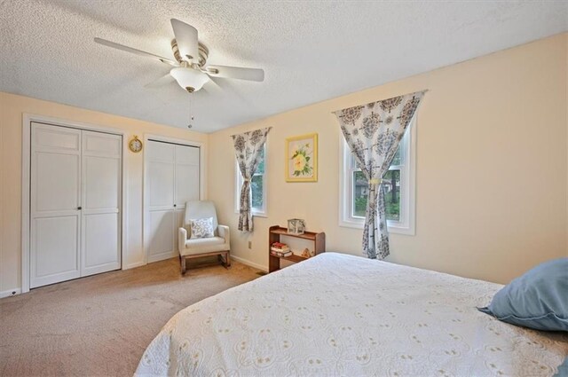 1621 Vilas St, Leavenworth, KS 66048 - bedroom featuring multiple closets, a textured ceiling, carpet floors, and ceiling fan