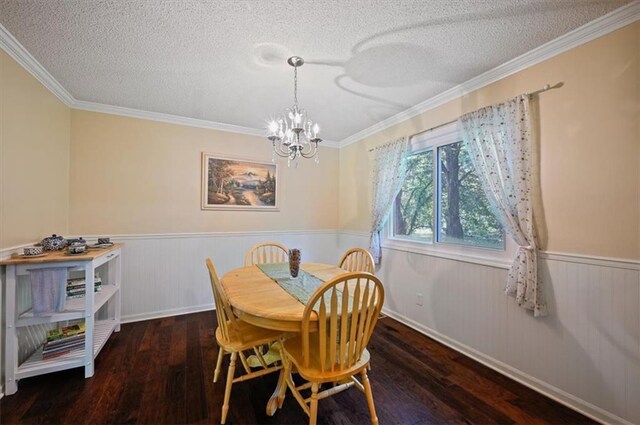 1621 Vilas St, Leavenworth, KS 66048 - dining area featuring a wainscoted wall, wood-type flooring, a chandelier, a textured ceiling, and ornamental molding