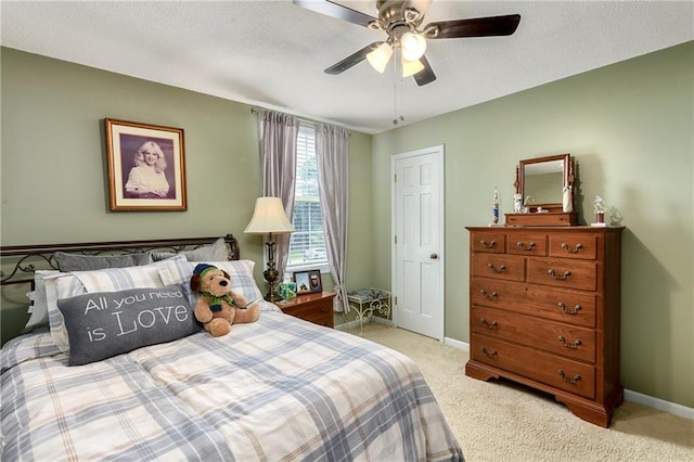 407 Maple Ct, Lansing, KS 66043 - bedroom with light colored carpet, ceiling fan, and a textured ceiling