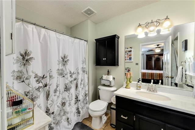 407 Maple Ct, Lansing, KS 66043 - ensuite bathroom with vanity, tile patterned flooring, ceiling fan, a textured ceiling, and curtained shower