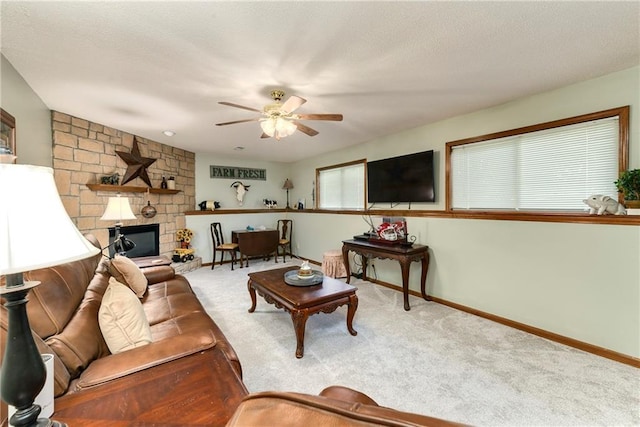 407 Maple Ct, Lansing, KS 66043 - carpeted living room with a ceiling fan and a stone fireplace