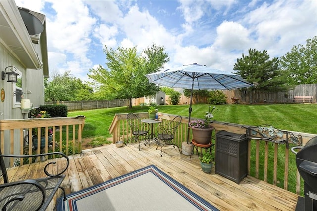 407 Maple Ct, Lansing, KS 66043 - wooden deck with a storage unit, a fenced backyard, and outdoor dining space
