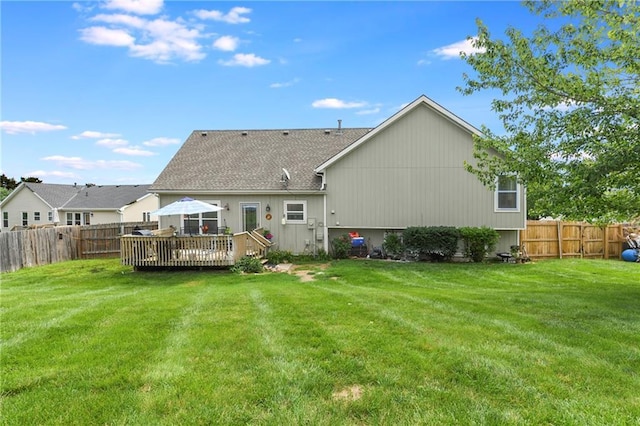 407 Maple Ct, Lansing, KS 66043 - rear view of property with a wooden deck, a fenced backyard, and a shingled roof