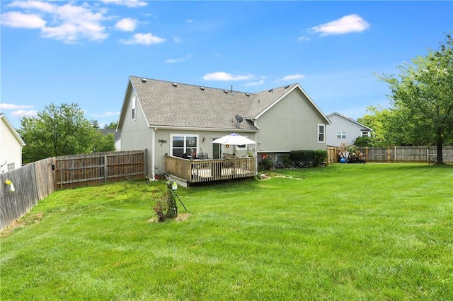 407 Maple Ct, Lansing, KS 66043 - back of property with a fenced backyard, a wooden deck, and roof with shingles