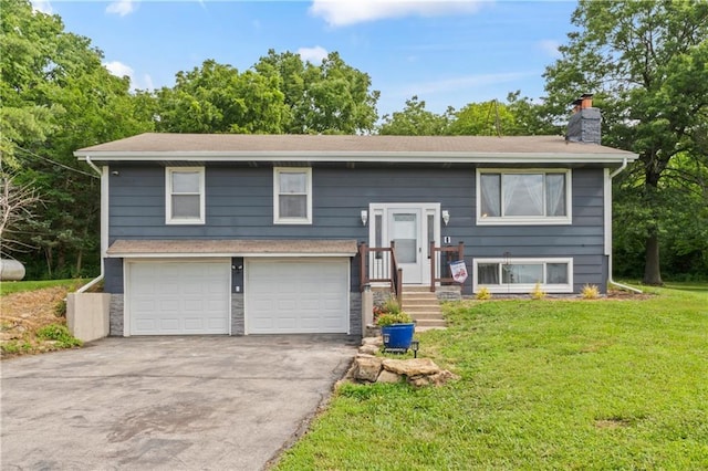 10708 E 301st St, Drexel, MO 64742 - raised ranch with a chimney, a front lawn, an attached garage, and driveway